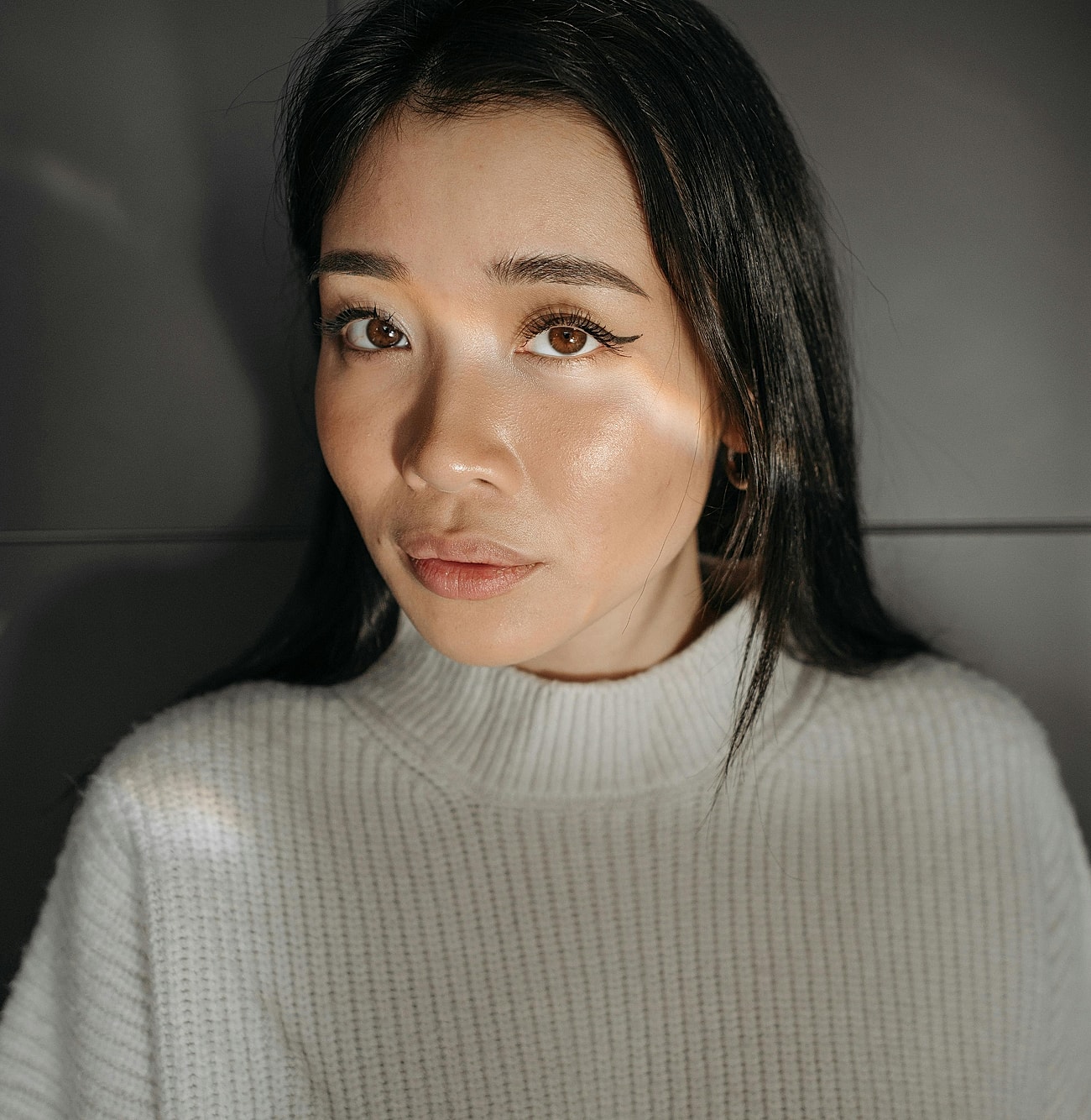 Woman with long hair in cozy sweater.